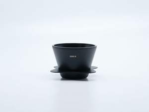 OREA 01 Obsidian Steel conical dripper with matte black finish and petal-shaped drip tray